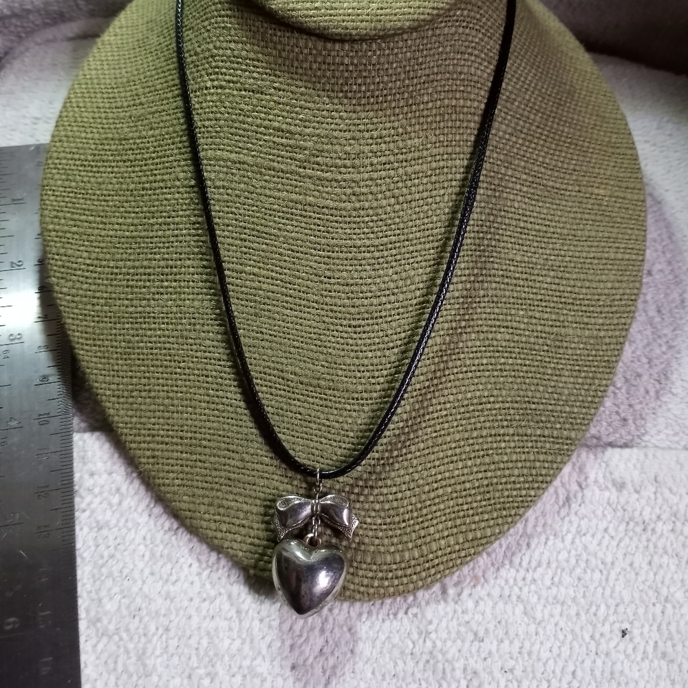 Silvertone heart bow pendant on black cord necklace